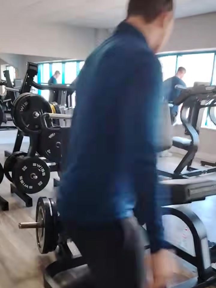 The Arena gym floor with plate-loaded machines on a timber floor